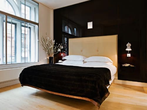 Maddox Street Apartments, Mayfair: Bed with tall cream headboard and black throw