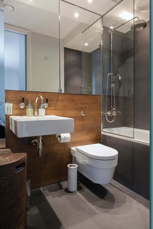 Sutherland Street 2 Bedroom Apartment, Pimlico: Bathroom with wood panel wall and wall-hung basin
