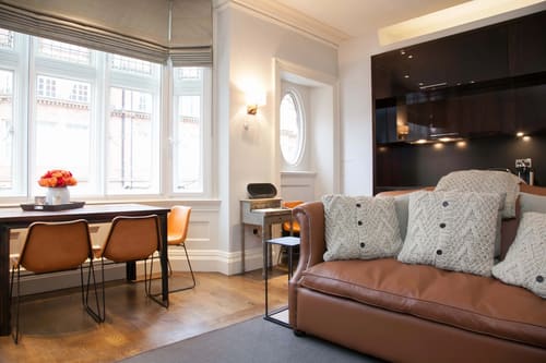 Prime Mayfair 1 bedroom no.1, W1K, Mayfair: Tan leather sofa with desk by the window