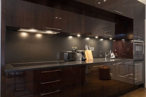 Prime Mayfair 1 bedroom no.1, W1K, Mayfair: Kitchen with dark units and under-cabinet lighting