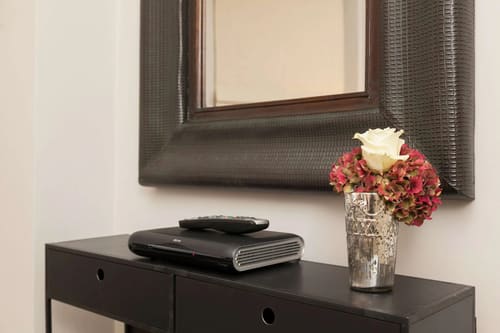 Prime Mayfair 1 bedroom no.2, W1K, Mayfair: Mirror above a console with roses