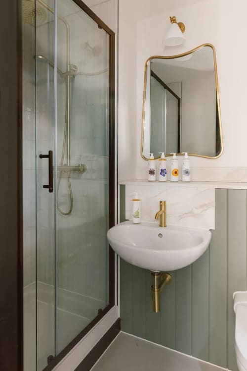 The St Paul’s Apartments, East London: Shower room with gold tap and basin