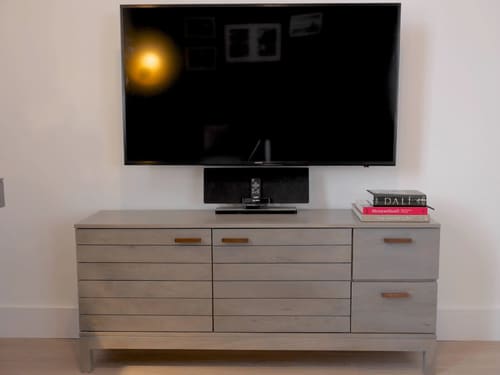 Nevern Place Apartments, Earl's Court: Wall-mounted TV above a grey sideboard