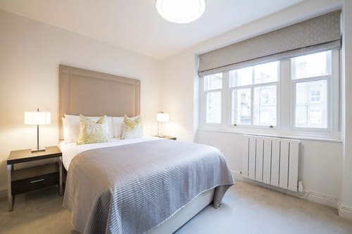 Nottingham Place Apartments, Marylebone: Double bedroom with grey headboard and sash windows