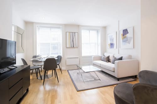 Nottingham Place Apartments, Marylebone: Living room with cream sofa and round dining table