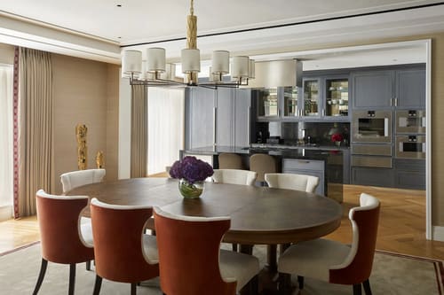 Ten Trinity, City of London: Round dining table with rust chairs and chandelier