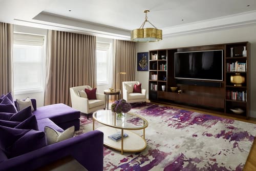 Ten Trinity, City of London: Living room with purple rug and TV wall