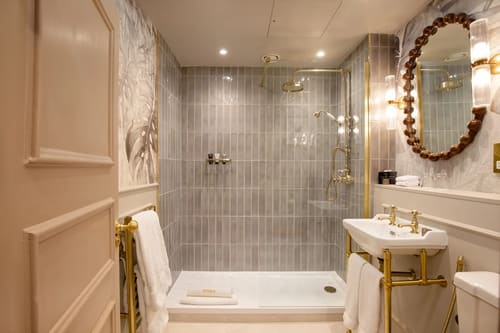 The Capital Apartments, Knightsbridge: Shower room with brass fittings and grey tiles