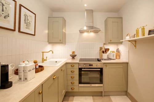 The Capital Apartments, Knightsbridge: Kitchen with sage units and brass tap