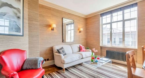Chelsea 1 bedroom near Kings Road, Chelsea: Cream sofa against grasscloth walls