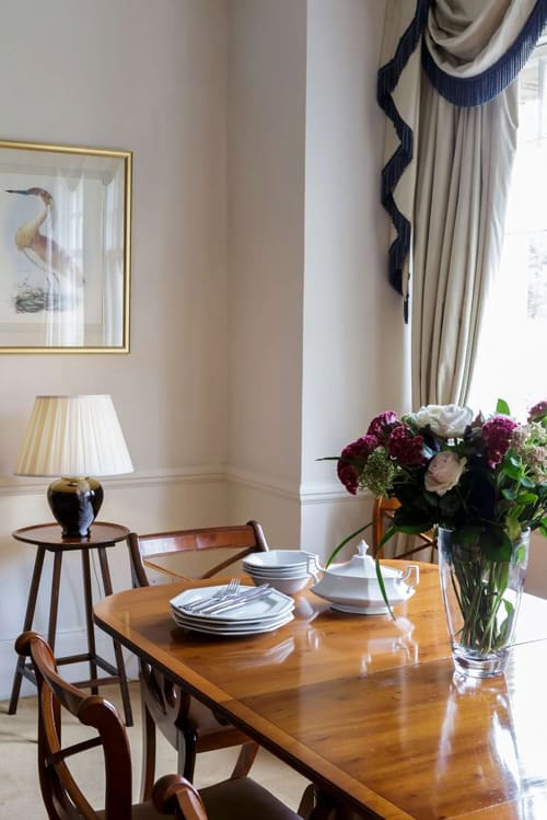 The Earls Court Road Apartments, Earl's Court: Dining table with flowers by the window