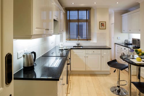 The Earls Court Road Apartments, Earl's Court: Kitchen with cream units and black worktop