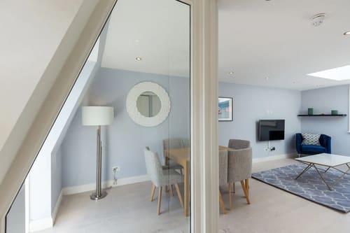 Floral Street Apartments, Covent Garden: Dining area with round mirror under a sloping ceiling