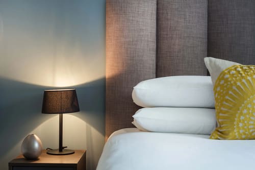 Waterloo Apartments, Waterloo: Bedside lamp beside a padded headboard