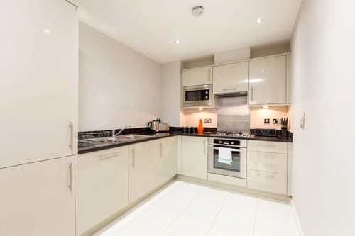 Waterloo Apartments, Waterloo: Kitchen with cream units and built-in microwave