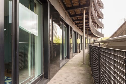 Waterloo Apartments, Waterloo: Walkway with glass doors along a modern building