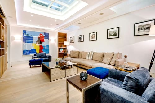 3-bedroom house near High St Kensington, Kensington: Living room with skylight, cream sofa and artwork