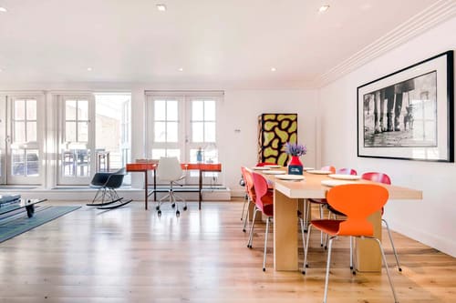 Covent Garden 3 bedroom, Covent Garden: Dining table with orange chairs by tall windows
