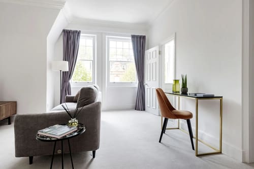 The Sloane Gardens Apartments, Chelsea: Sitting area with armchair and desk by the window