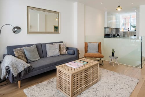 Fitzrovia 2 bedroom near Oxford Street, Fitzrovia: Living room with grey sofa and rattan coffee table