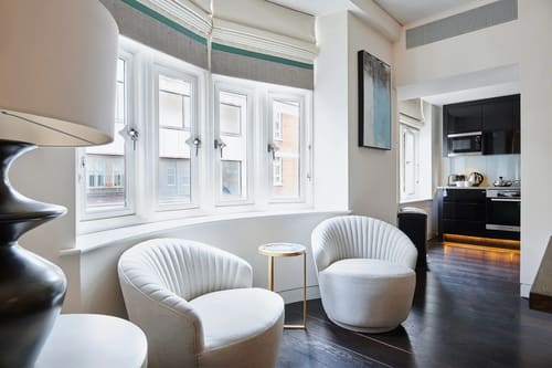 Duke St, W1K, Mayfair: Reading corner with white swivel chairs