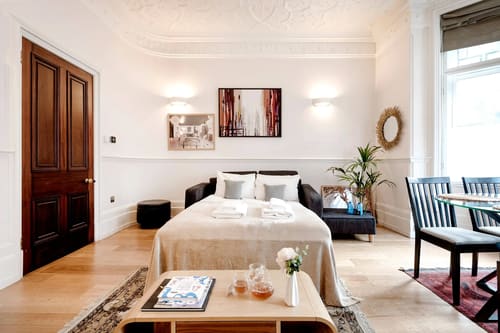 Mayfair 1 bedroom near Green Park, Mayfair: Bedroom with sofa and framed artwork