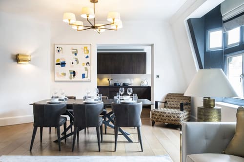 Duke St, W1K, Mayfair: Dining table with grey chairs and open kitchen beyond