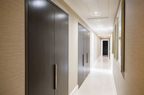 Duke St, W1K, Mayfair: Long hallway with dark fitted wardrobes