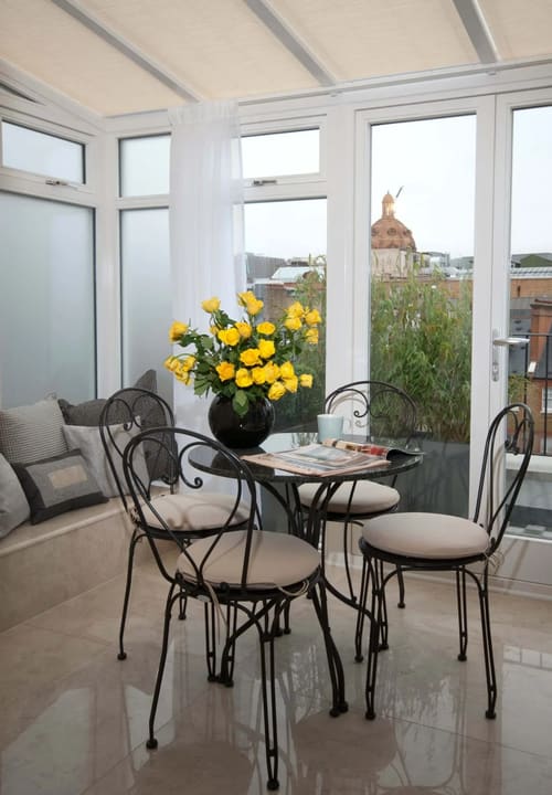 Claverley Court, Knightsbridge: Bistro table with yellow roses by window