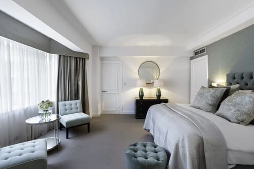 Arlington House, Mayfair: Bedroom with grey headboard and armchair