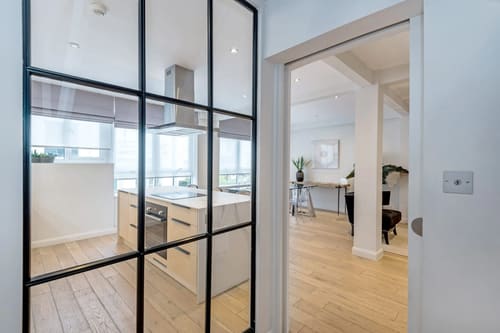 Hyde Park Gate, Kensington: Kitchen behind black-framed glass partition