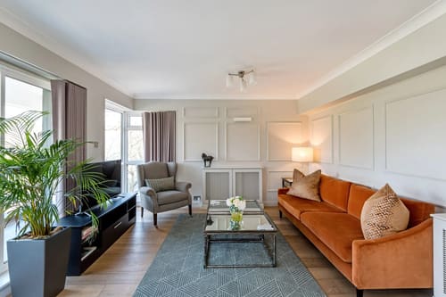 Hyde Park Gate, Kensington: Living room with orange velvet sofa and panelled walls