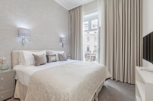 Chesham Place, Chelsea: Double bedroom with tall curtained windows