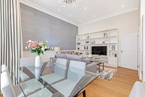 Chesham Place, Chelsea: Living and dining room with glass table and white shelving
