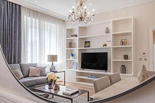 Chesham Place, Chelsea: Living room with shelving, TV and chandelier