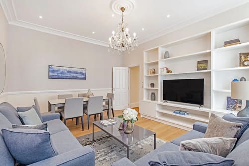 Chesham Place, Chelsea: Living and dining room with chandelier and TV unit