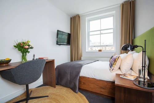 Lancaster Gate Apartments, Paddington: Bedroom with desk and wall-mounted TV