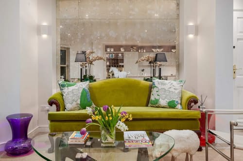 Covent Garden 2 bedroom near Opera House, Covent Garden: Lime green sofa with patterned cushions and flowers