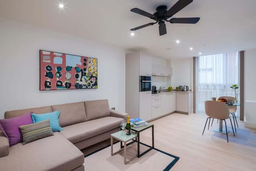 The Chancery Lane Chronicle, East London: Living room with ceiling fan and kitchen beyond