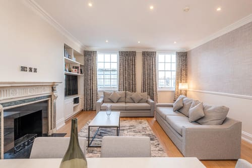 Hertford Street, Mayfair: Living room with fireplace and draped windows