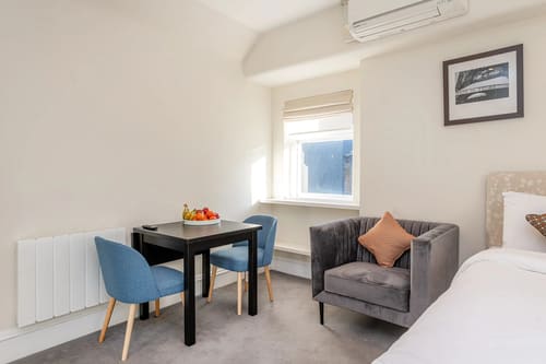 Hertford Street, Mayfair: Dining table with blue chairs and armchair