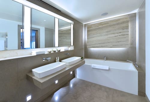 Duke St, W1K, Mayfair: Bathroom with twin basins and backlit mirror