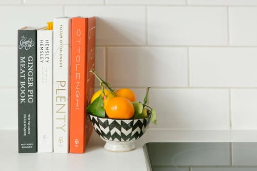 The Little Venice Apartments, Little Venice: Cookbooks and fruit bowl on kitchen counter