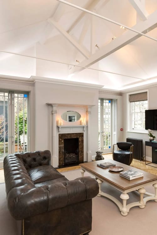 The North Audley Apartments, Mayfair: Fireplace with mirror and French windows