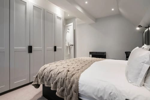 The North Audley Apartments, Mayfair: Bedroom with grey panelled wardrobes