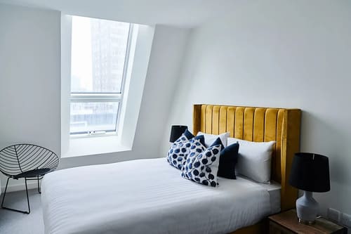 The Shoreditch Warehouse Apartments, East London: Double bedroom with mustard velvet headboard