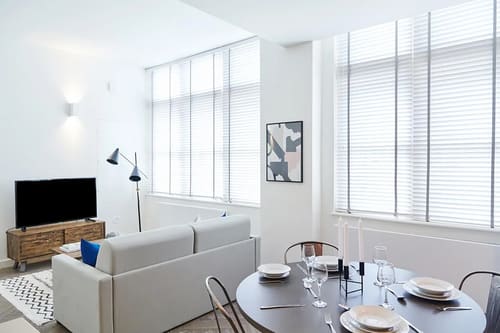The Shoreditch Warehouse Apartments, East London: Living room with tall windows and blinds