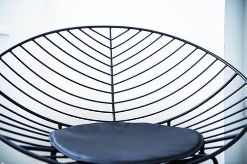 The Shoreditch Warehouse Apartments, East London: Detail of a wire leaf-pattern chair