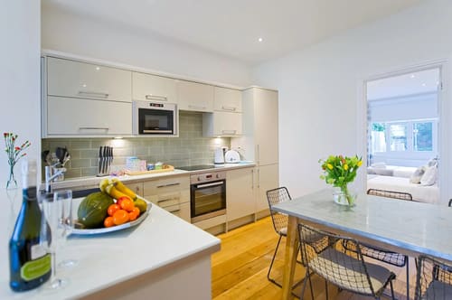 The Claygate Apartments, Claygate: Kitchen with cream units and dining table