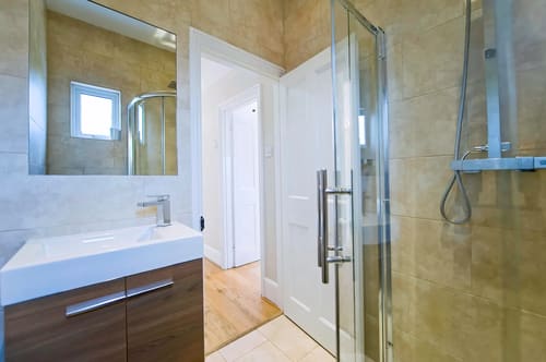 The Claygate Apartments, Claygate: Shower room with glass door and marble walls